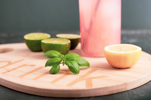 Close-up of basil leaves in a glass of lemonade.