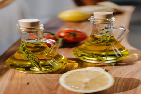 Close-up of lemon vinaigrette being drizzled on a salad.