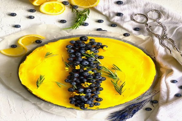 A slice of asparagus tart being lifted from the whole tart.